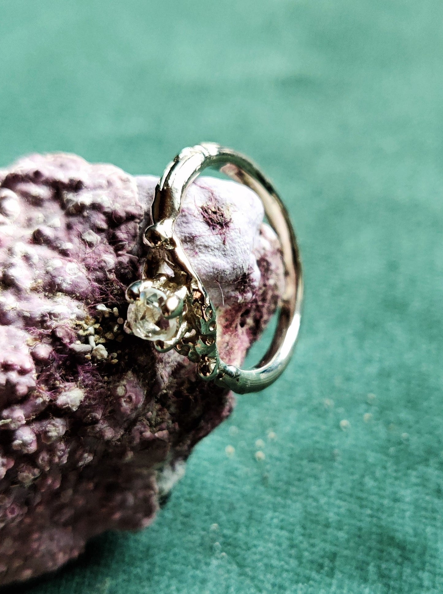 Een verlovingsring met een vintage look and feel in het wit goud. Een solitair met een roosgeslepen diamant dat in een opengewerkt bandje staat.