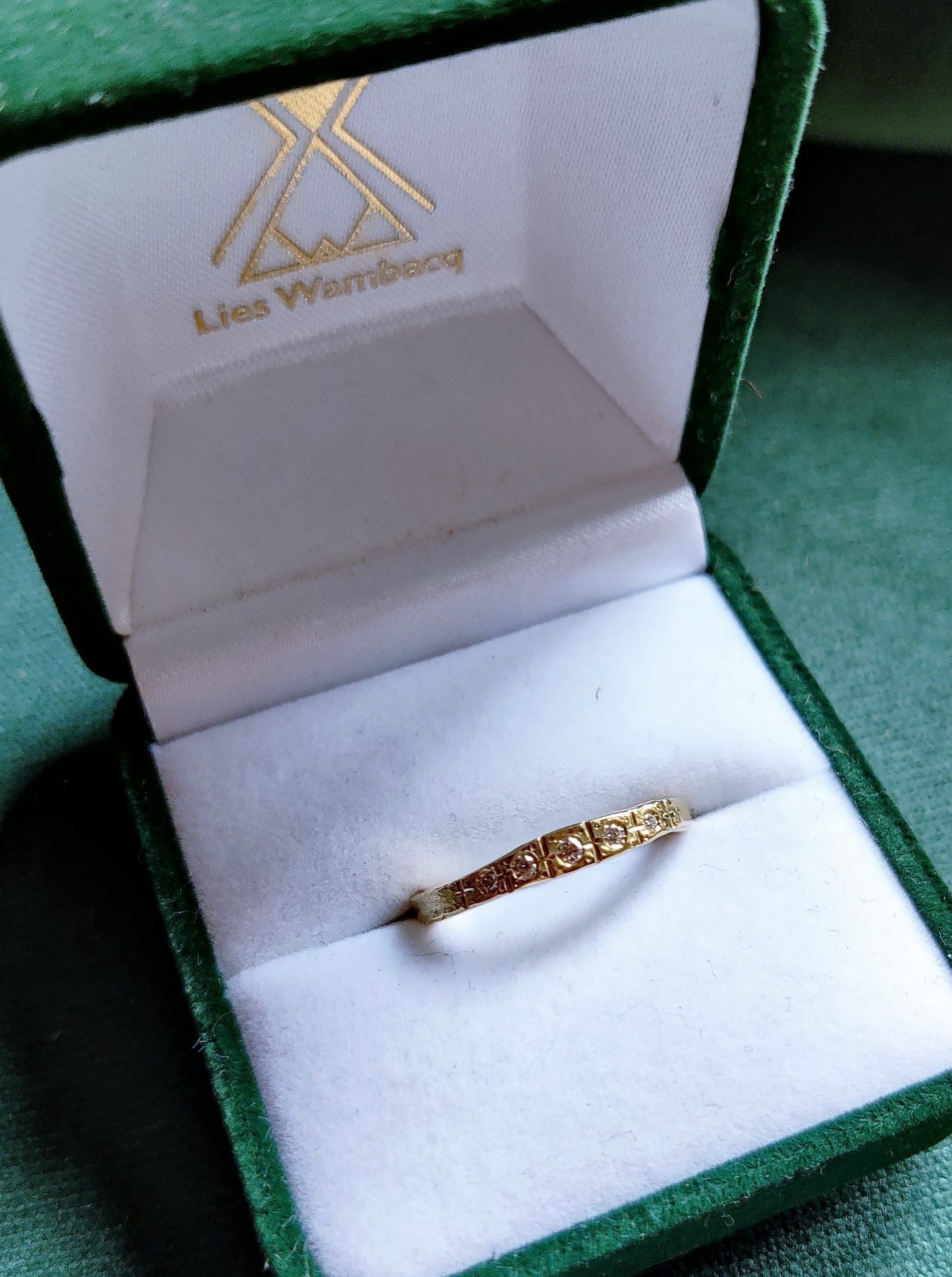 Smalle ring in 18k geel goud met witte diamanten. De ring lijkt wel uit de art deco tijd te komen. Het is een geel gouden ring met allemaal lijntjes met de hand in gegraveerd. Deze ring kan perfect als trouwring of als ring om bij andere ringen gedragen te worden. 
