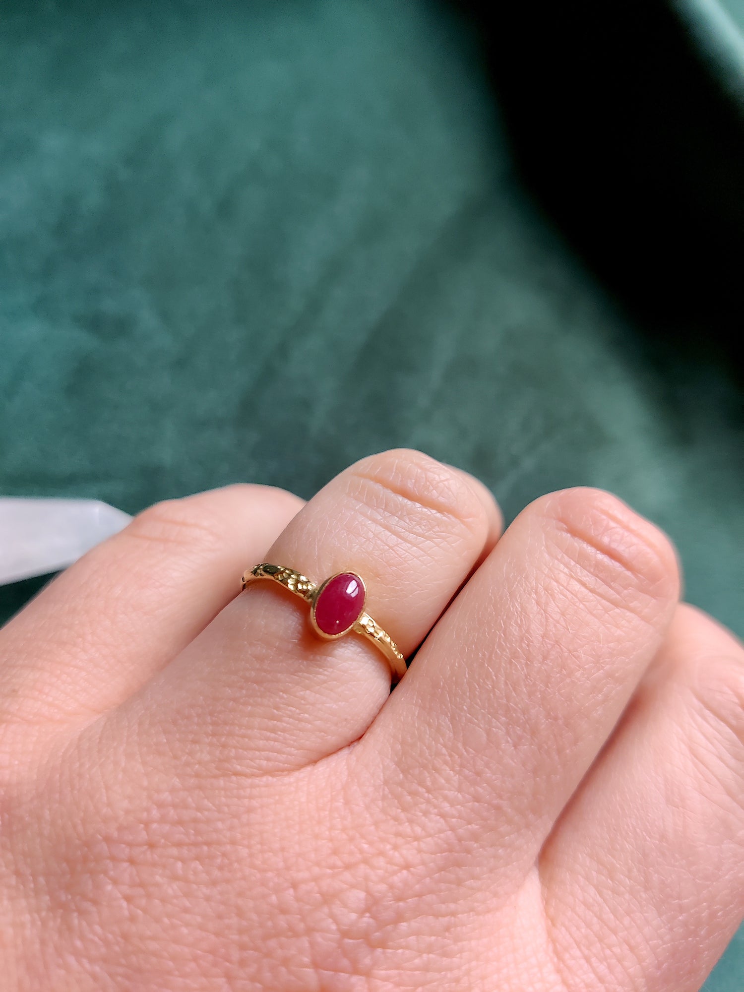 18K geel gouden ring met een matte ovale robijn. De rode edelsteen is in een toe potje gezet op een band met motief. Een romantische stoere en fijne ring.